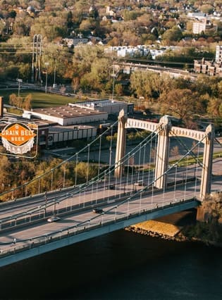 Stone Arch Bridge and Grain Belt sign in Minneapolis, Minnesota, representing TMC’s contract therapy services across the state.