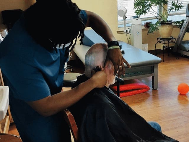 Therapist cutting patient's hair