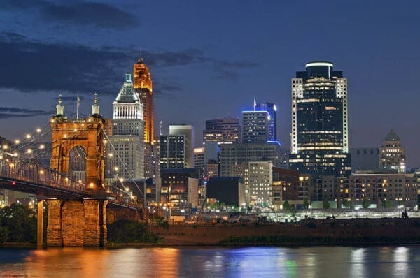 Cincinnati skyline. Image of Cincinnati and John A. Roebling suspension bridge at night.