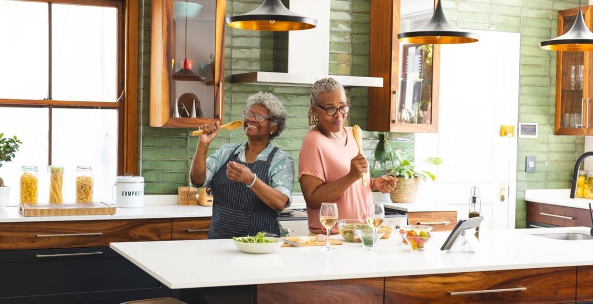 Older adults preparing a meal together in a home setting, representing independence, daily function, and quality of life supported through clinical excellence.
