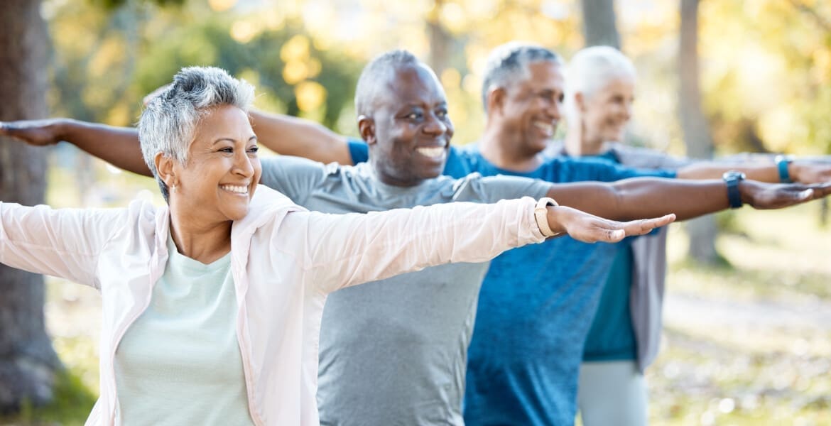 Stretching, yoga and senior people in park for muscle health, workout and training with retirement .