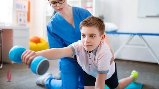 Occupational therapy assistant helping child improve motor skills with therapy exercises